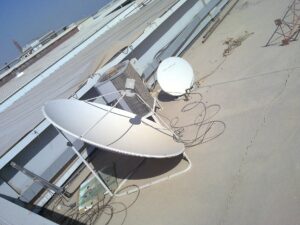 A satellite dish pointing at the sky at a ground station